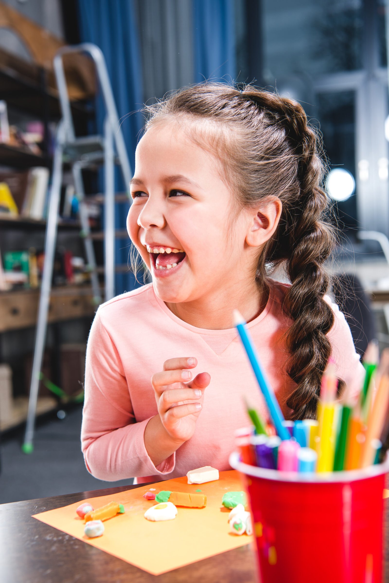 Portrait of happy kid playing with plasticine